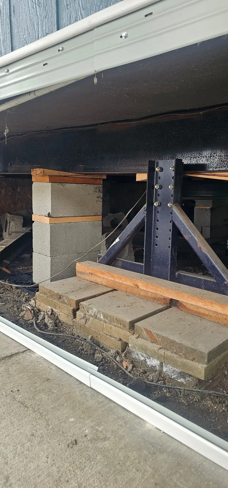 New block pier and steel support stand under a mobile home