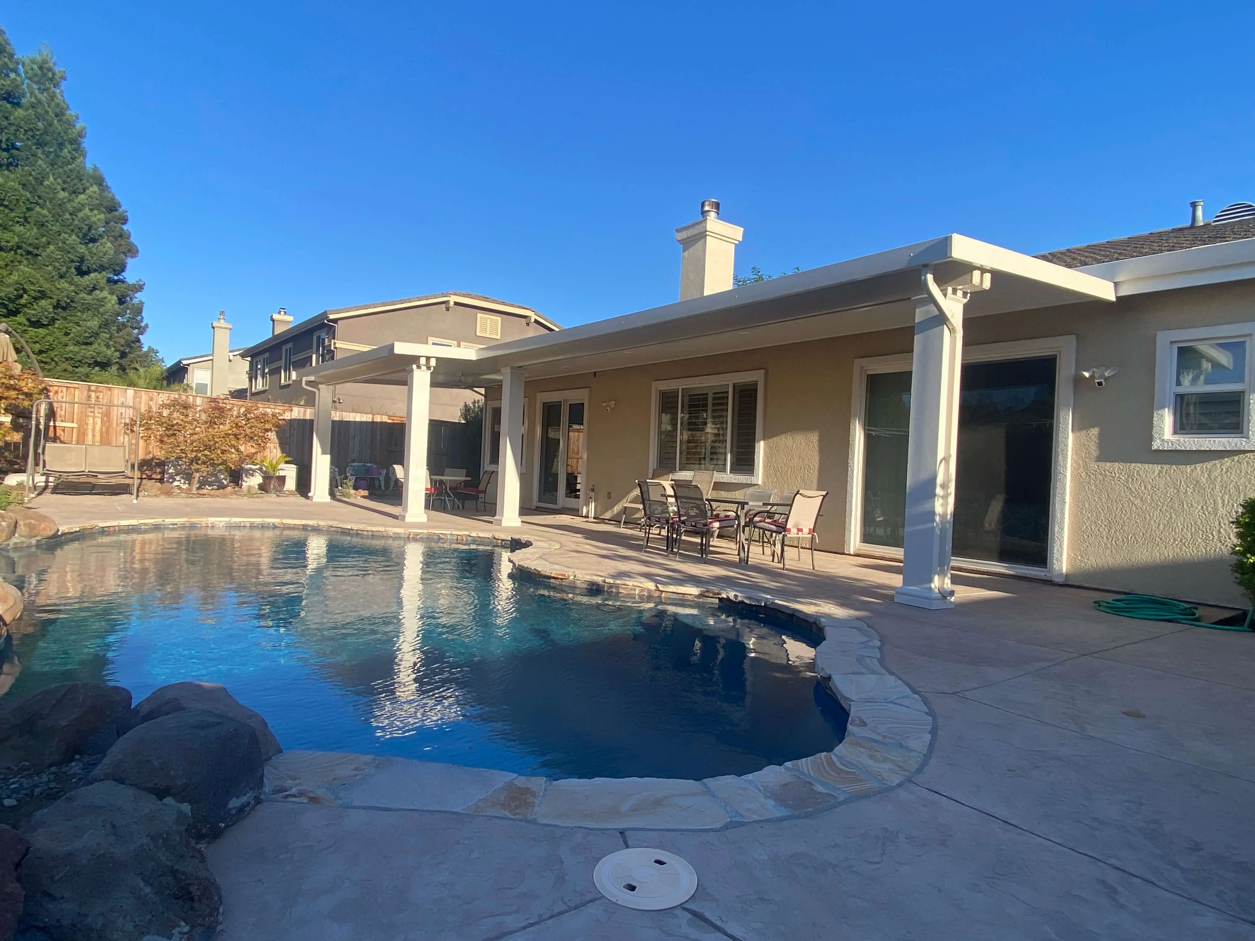 Patio covers over a poolside backyard